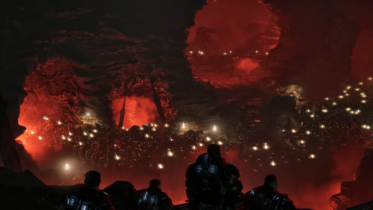 Quatre Gears vus de dos observent une armée de Locustes rassemblée dans une caverne rougeoyante dans Gears of War: E-Day
