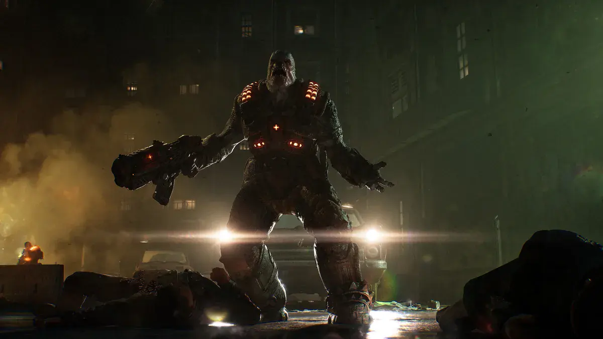 Un Locuste massif, arme à la main, se dresse au-dessus de corps étendus dans une rue de nuit, devant les phares d'une voiture, dans Gears of War: E-Day