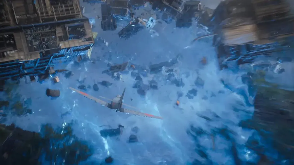 Godzilla Minus Zero : un avion de chasse traverse un tourbillon d'eau et de débris au-dessus des toits d'une ville