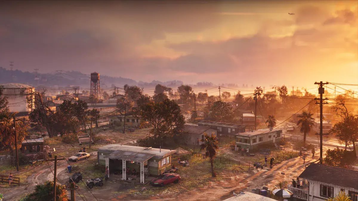 GTA 6 : vue aérienne de Port Gellhorn au coucher du soleil, mobil-homes, château d'eau et palmiers, capture officielle Rockstar