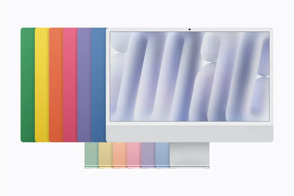 Les sept coloris de l'iMac M6, du vert au bleu, rangés derrière un iMac argent