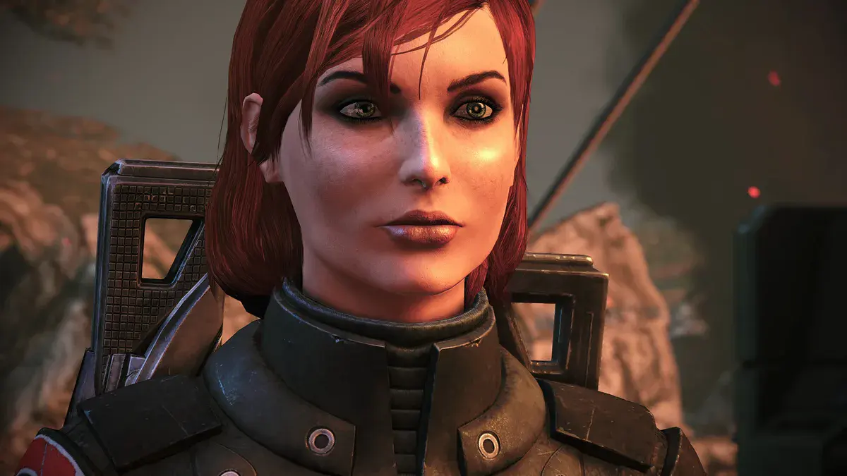 Le commandant Shepard, en version féminine et en armure, en gros plan dans Mass Effect Édition Légendaire