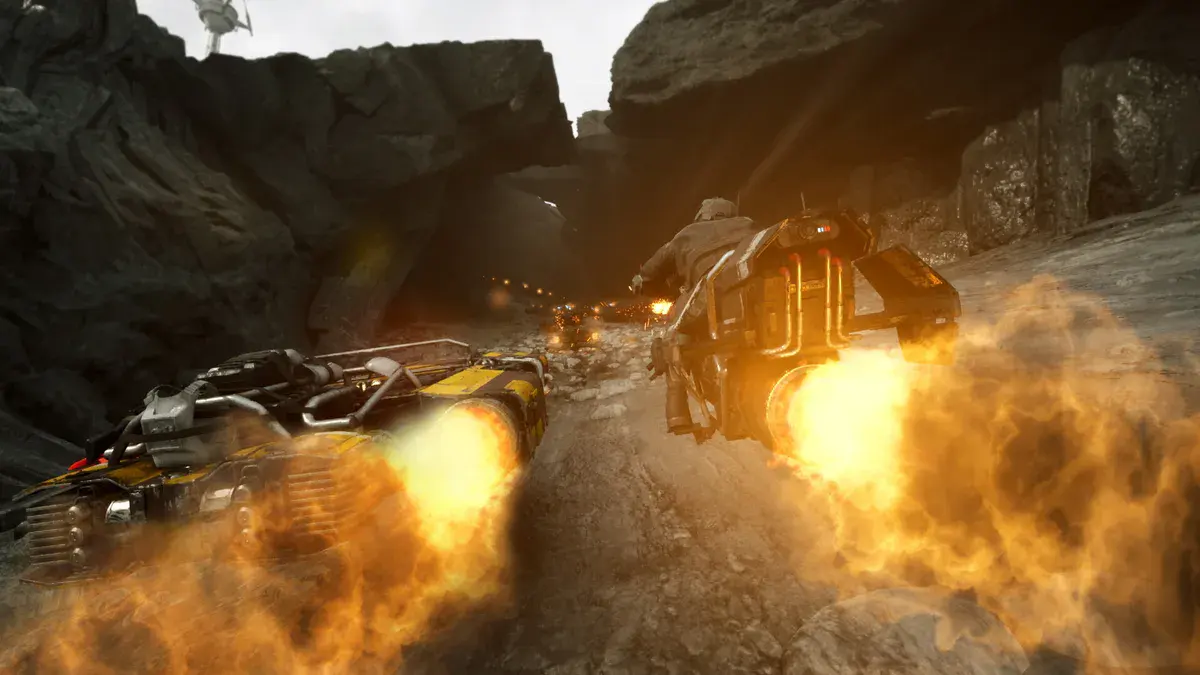 Un landspeeder jaune et noir et une motojet filent dans un canyon rocheux, réacteurs en feu, dans Star Wars: Galactic Racer