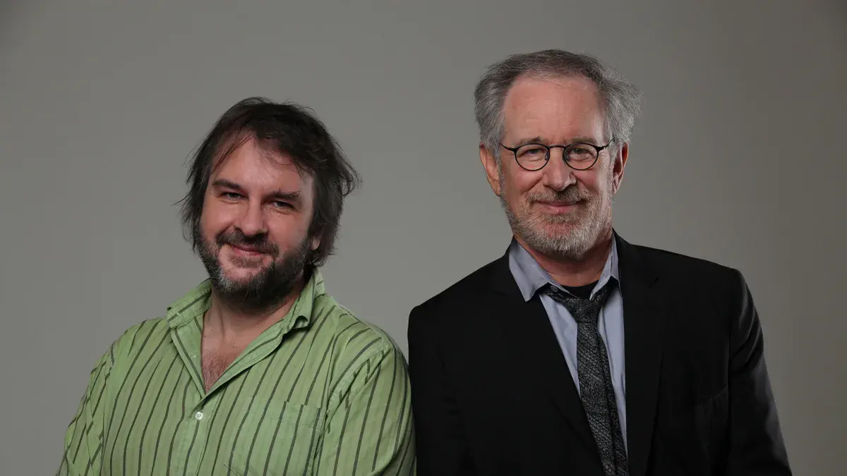 Peter Jackson, chemise verte à rayures, et Steven Spielberg, costume sombre et lunettes rondes, posent côte à côte pendant la promotion des Aventures de Tintin