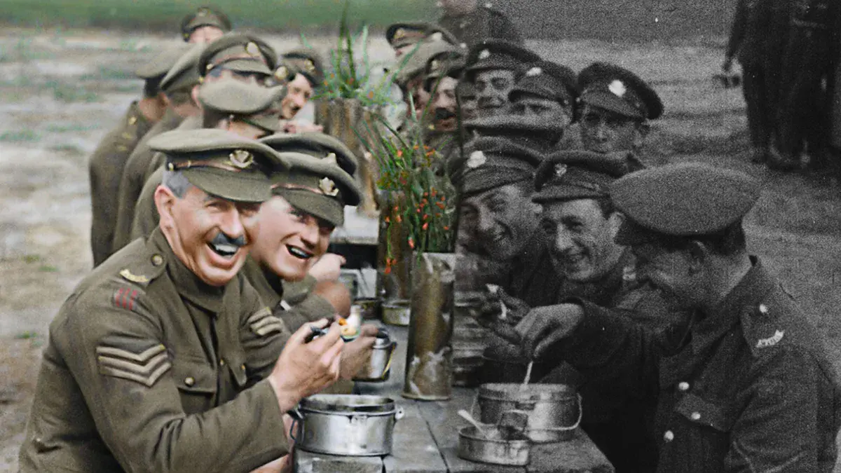Pour les soldats tombés : soldats britanniques souriants attablés dans une tranchée, image d'archive en partie colorisée