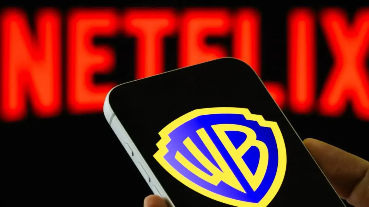 warner bros logo on phone with netflix logo blurred in background 1